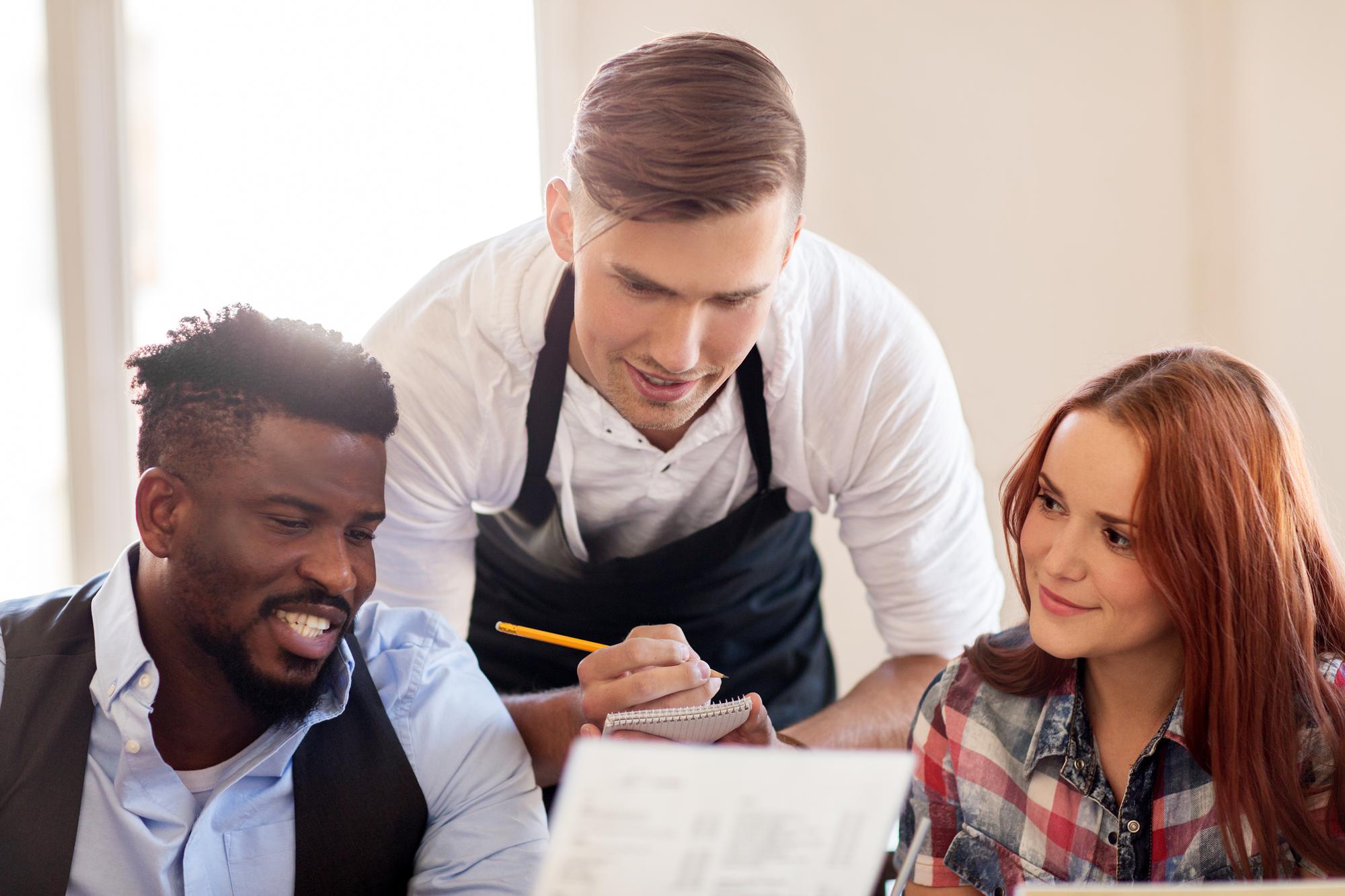 Chef and client discussing menu details over notes